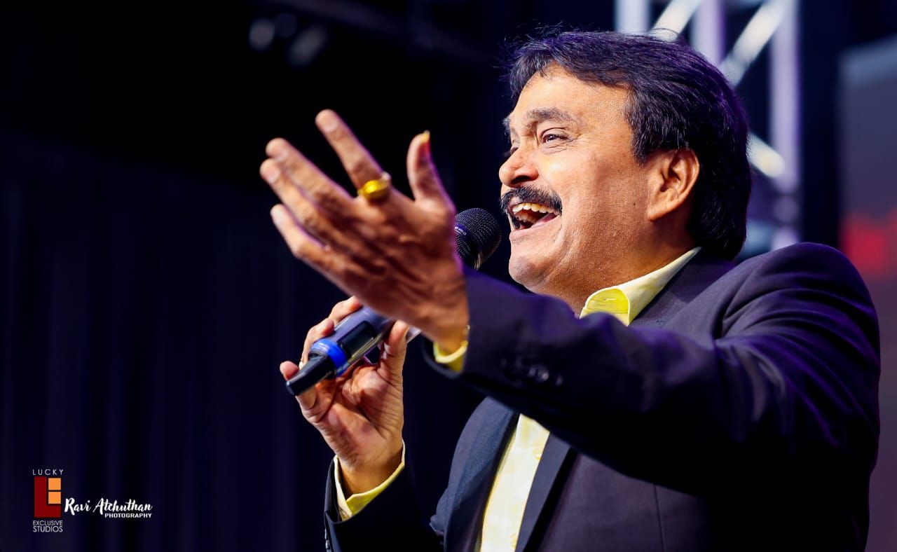 Ramu performing with outstretched hand