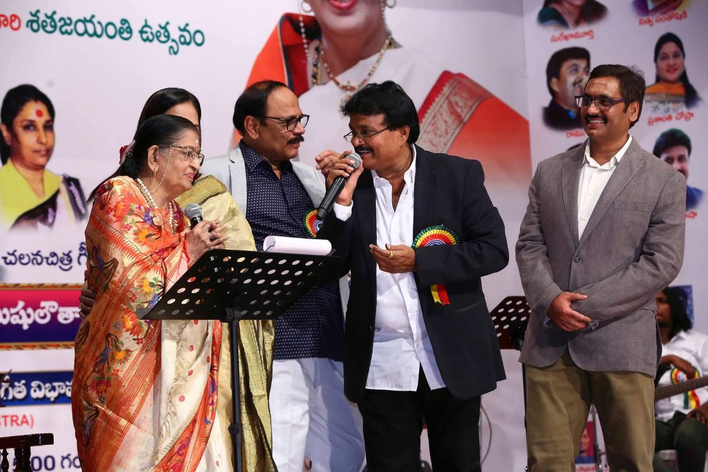 Ramu singing on stage alongside fellow artists