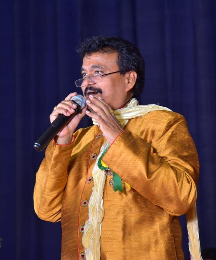 Ramu singing in a gold kurta