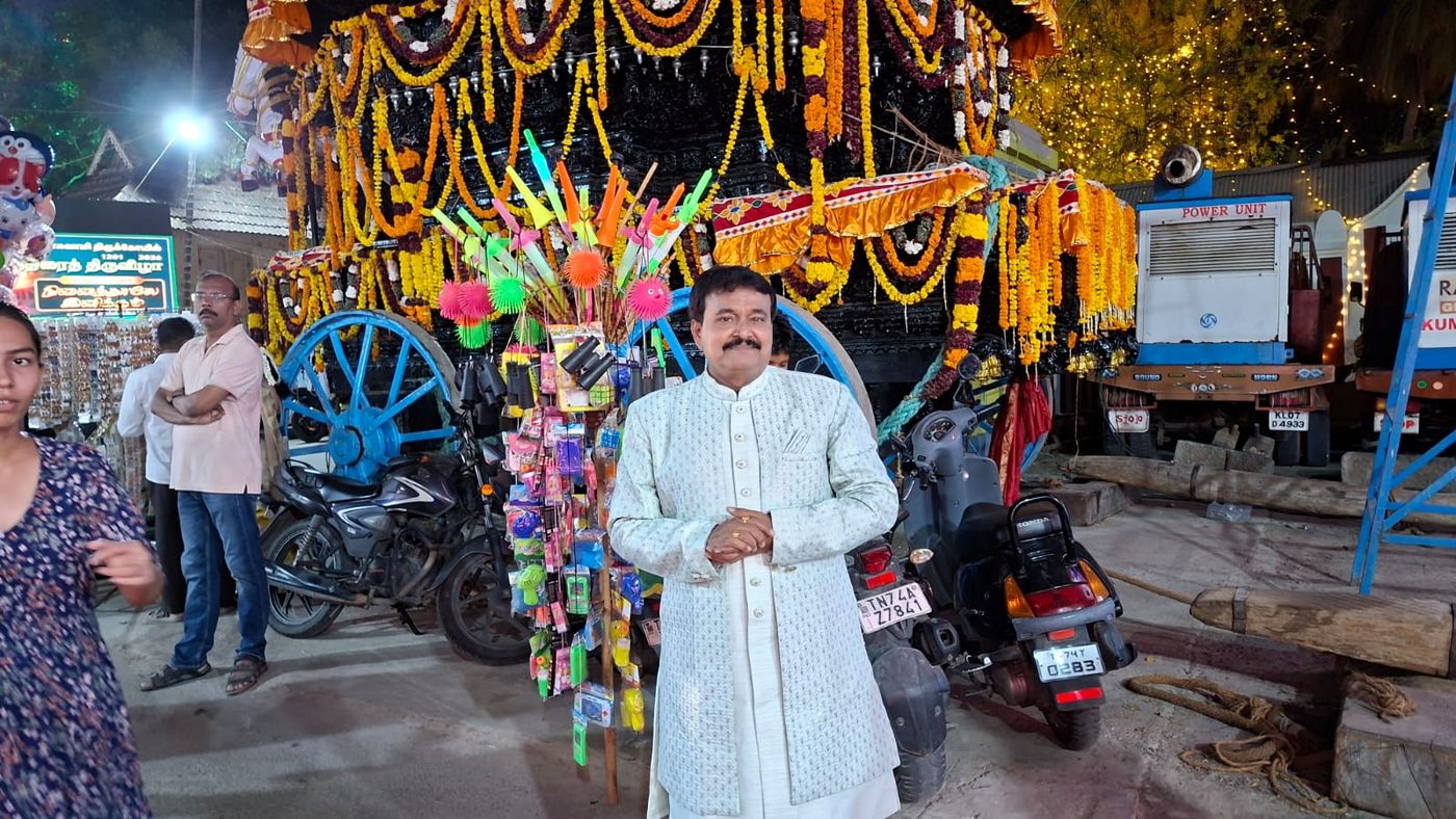 Ramu at a temple festival beside a decorated chariot